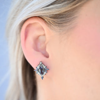 Model wearing the Nightbriar lab-grown alexandrite stud earring in black ruthenium
