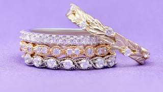 Silver, rose gold and yellow gold pave eternity bands stacked beside a gold leaf band on lilac, Aquamarise Labor Day sale mobile banner