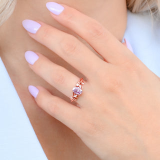 Lavender moissanite fairy leaf ring in rose gold worn on a model's hand