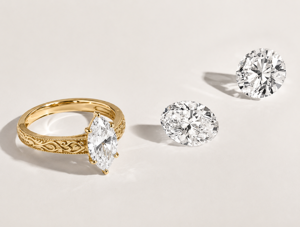 Marquise cut diamond engagement ring with vintage scrollwork detailing by Aquamarise
