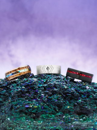 Three rings on a textured surface with a purple gradient background