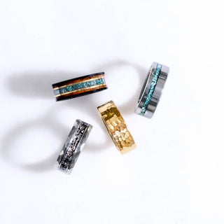 Five rings with different designs and colors on a white background