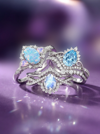 Silver ring with blue gemstones on a purple background