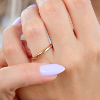 Minimalist Wedding Band in Rose Gold Tungsten (2mm) worn on the hand