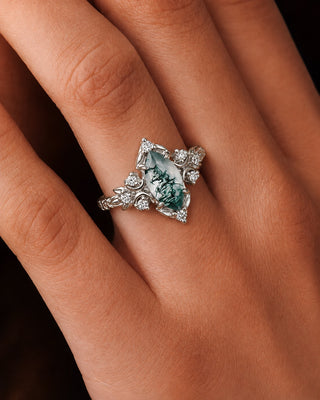 Sterling silver marquise moss agate engagement ring with diamond accents worn on a hand, Aquamarise lifestyle banner