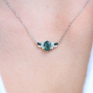 Model wearing the moss agate and opal cluster necklace in sterling silver at the collarbone