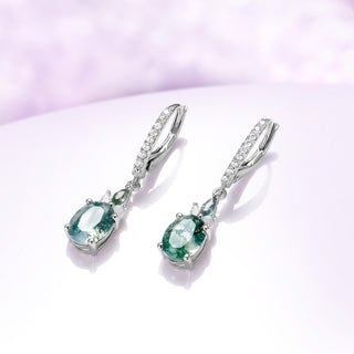 Side view of the sterling silver moss agate drop earrings showing the leverback closure and white opal accent