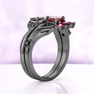 Side profile of the two-piece garnet Claddagh ring set in black ruthenium, the two bands sitting flush with a black onyx on the shoulder