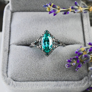 Nerida Lab-Grown Paraiba Blue Spinel Engagement Ring in Black Ruthenium in a gray velvet ring box