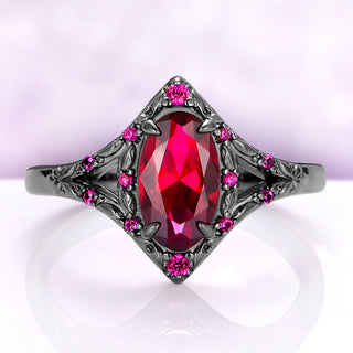 Nerida Lab-Grown Ruby Engagement Ring in Black Ruthenium by Aquamarise, oval red ruby in a kite-shaped frame of engraved leaves with ruby accents