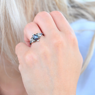 Noraleaf lab-grown alexandrite engagement ring in black ruthenium worn on a model's hand