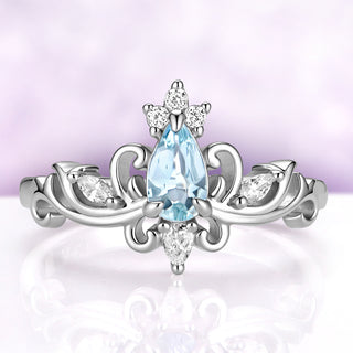 Odette pear aquamarine tiara engagement ring in sterling silver, 4 x 7 mm natural aquamarine crowned with cubic zirconia on a scrolled crown setting, front view