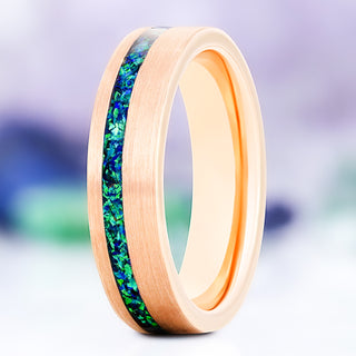 Peacock green fire opal wedding band in brushed rose gold tungsten, 6mm, standing view showing the blue-green opal inlay and polished rose gold interior