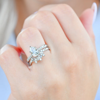 Pear white sapphire Art Deco bridal ring set in sterling silver worn on a model's hand