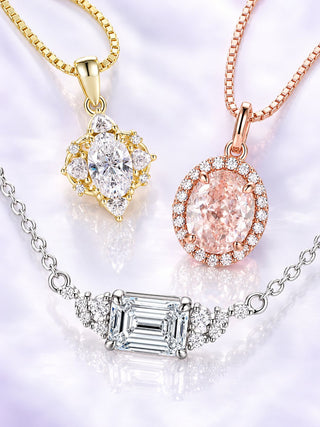 Three necklaces on lilac satin: marquise cluster pendant in yellow gold, oval pink halo pendant in rose gold and an east-west emerald-cut station necklace in white metal, Aquamarise banner