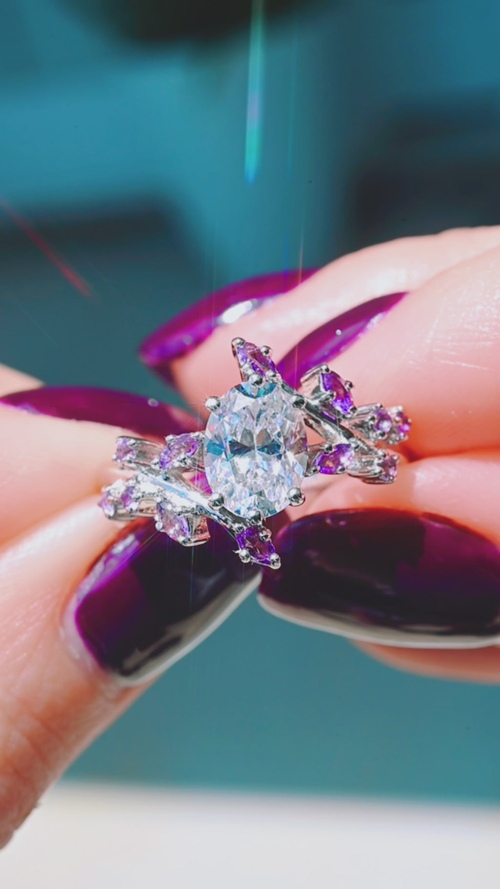 Product video of the Oval Lab Diamond & Amethyst Leaf Engagement Ring in 14K White Gold by Aquamarise, showing the oval lab-grown diamond with amethyst leaf accents.
