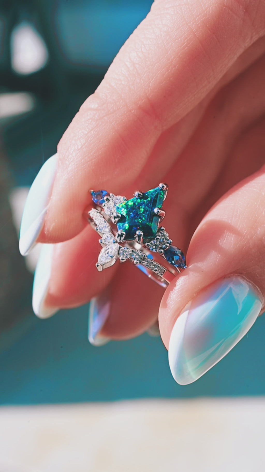 Product video of the Skye Kite Blue Fire Opal & Topaz Engagement Ring Set in 14K White Gold by Aquamarise, showing the kite-cut blue fire opal with topaz accents.