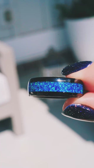 Video of the crushed blue opal black tungsten band in motion, showing the blue-green flash across the inlay
