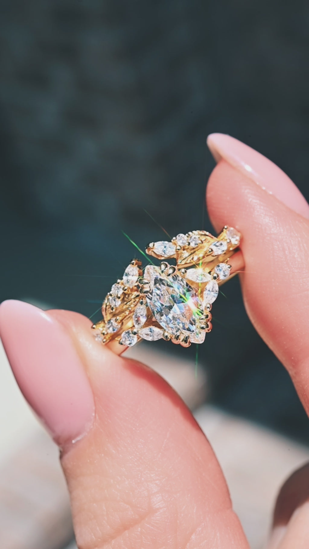 Video of a marquise diamond engagement ring set with leaf band by Aquamarise Gold, shown in motion