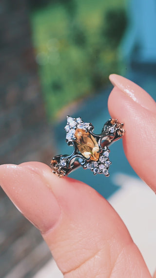 Artemisia marquise natural citrine engagement ring in black ruthenium turning in the light between fingertips
