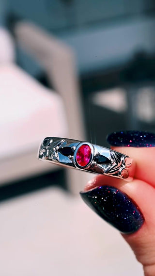 Video of the 6mm ruby and black onyx sterling silver wedding band turning in sunlight