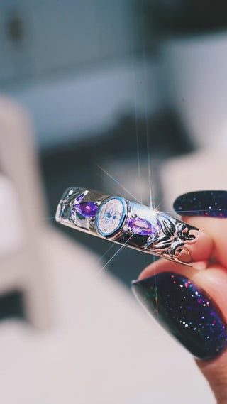 Video of the 6mm moissanite and amethyst sterling silver wedding band turning in sunlight