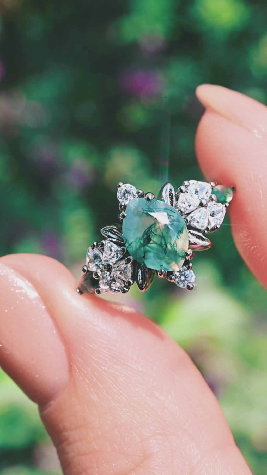 Video of the Noraleaf moss agate engagement ring turning in the light, showing the green dendritic inclusions