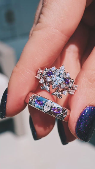 Video of the Carmilla moissanite and amethyst couples ring set, her ring with enhancer and his 6mm band held together in sunlight