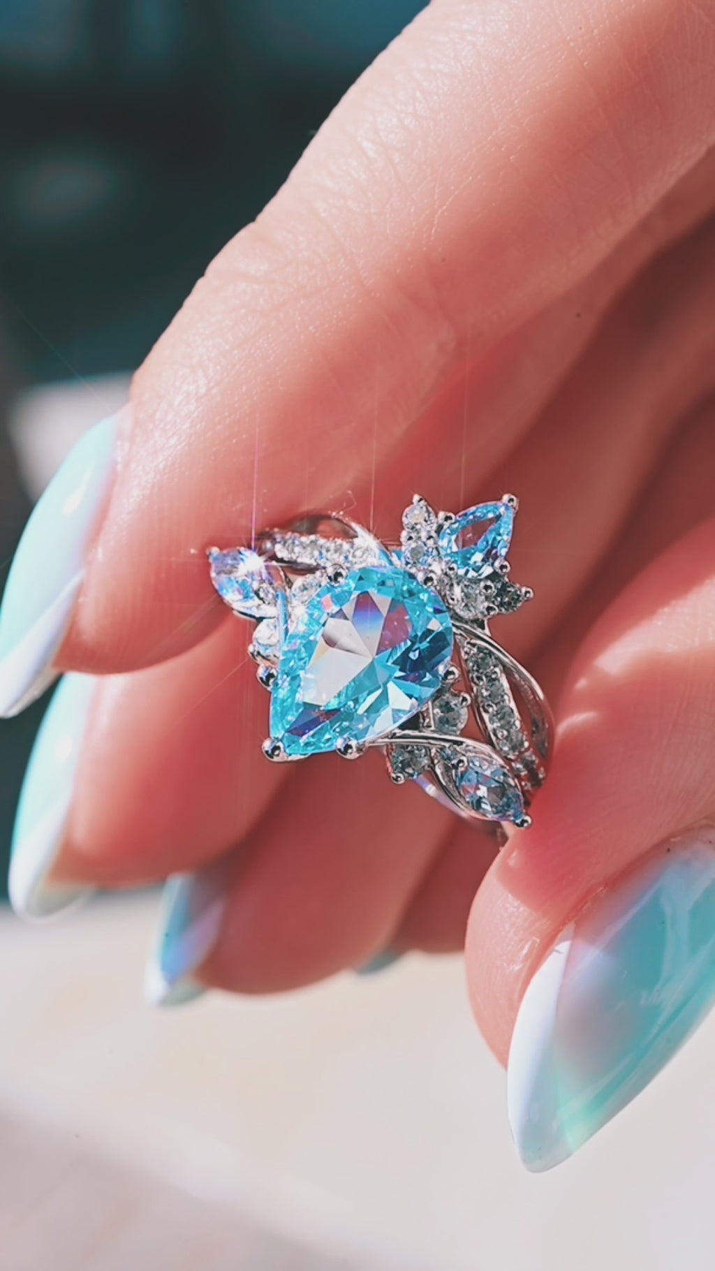 Product video of the Feyra Aquamarine Crown Wedding Band in 14K White Gold by Aquamarise, showing the aquamarine accents along the curved crown band.