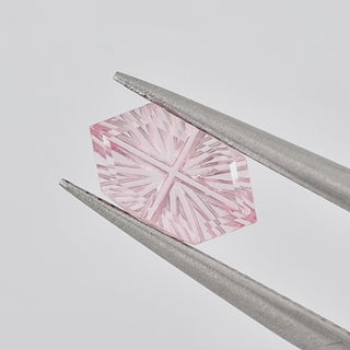 Lab-Grown Pink Sapphire long hexagon 6 x 10 mm Faelight Cut video, turning to show the starburst flashes