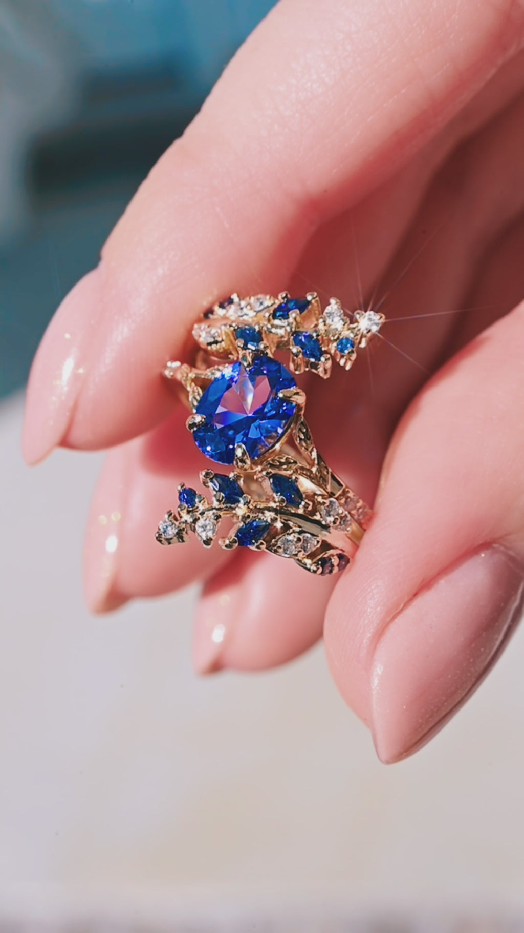Video of a gold leaf blue sapphire ring set by Aquamarise, shown in motion