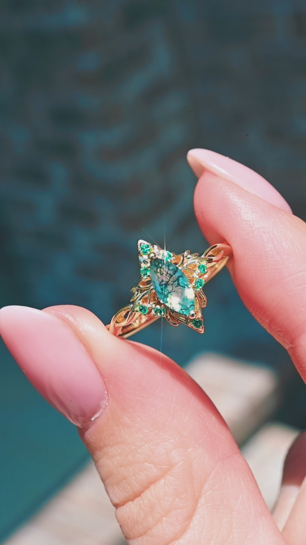 Product video of the Fairy Queen Moss Agate & Emerald Lotus Engagement Ring in Solid 14K Yellow Gold by Aquamarise, showing the moss agate center with emerald accents.
