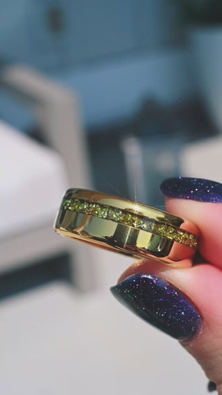 Video of the off-set crushed peridot gold tungsten band in motion, showing the green inlay sparkle in sunlight