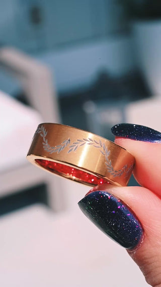 Video of the laurel vine gold titanium men's band showing the etched leaves and the red garnet sleeve inside