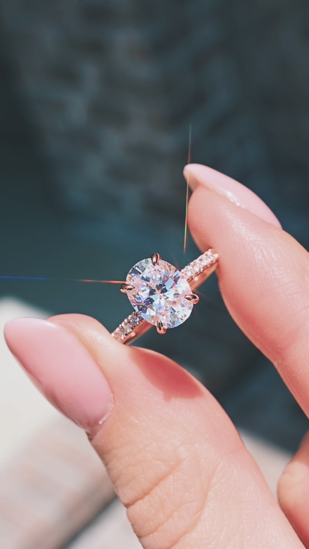 Video of an oval hidden halo solitaire engagement ring by Aquamarise, shown in motion