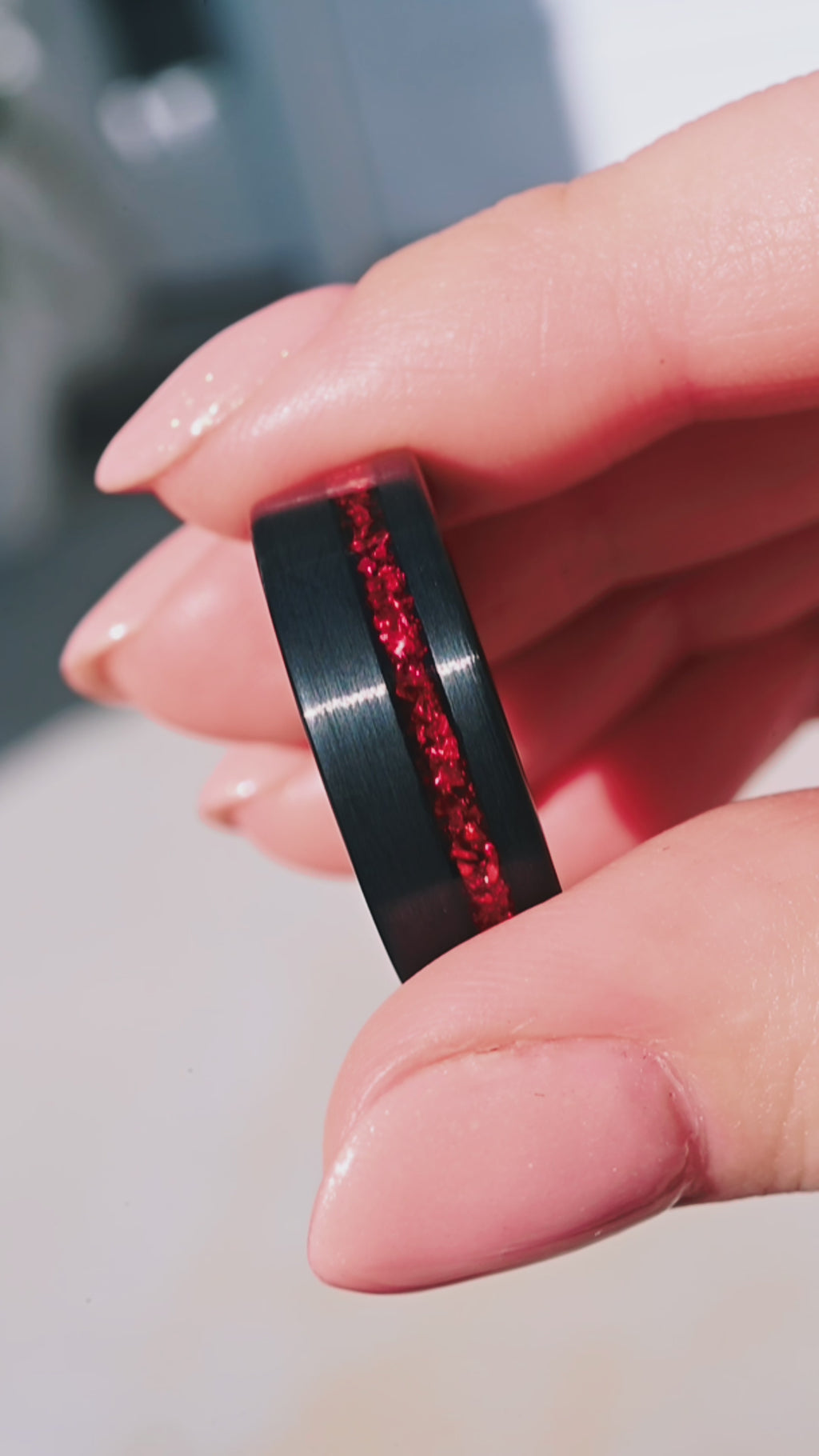 Video of a red ruby tungsten wedding band by Aquamarise, shown in motion