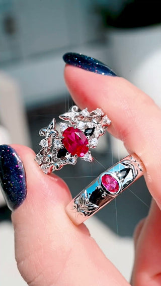 Video of the Carmilla ruby and black onyx couples ring set, her bridal set and his 6mm band held together in sunlight