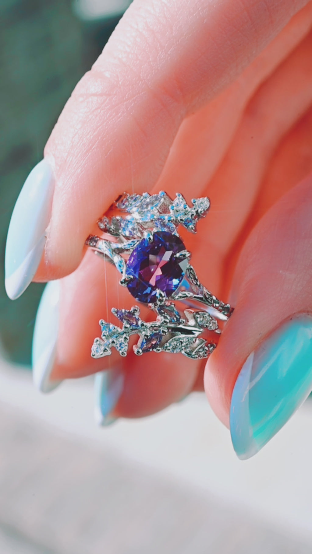 Product video of the Alexandrite Leaf Engagement Ring Set in 14K White Gold by Aquamarise, showing the alexandrite center with leaf-detailed bands.