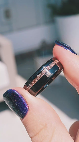 Video of the off-set crushed morganite black tungsten band in motion, showing the pink inlay catch the light