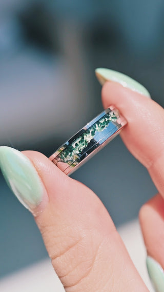 Hand holding moss agate mountain landscape tungsten ring