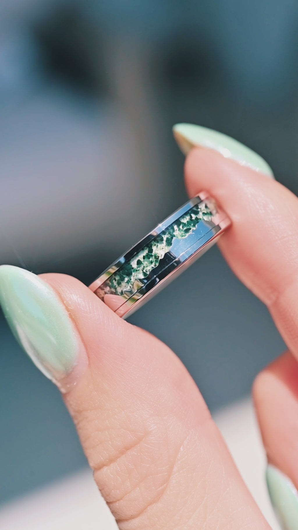 Hand holding moss agate mountain landscape tungsten ring