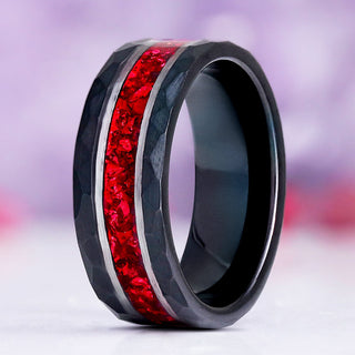 Red Garnet men's wedding band standing upright, hammered black tungsten with silver rails and a crushed red garnet inlay