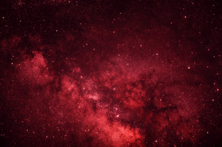 Red galaxy or nebula with stars against a dark background