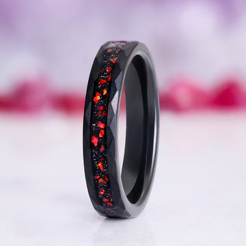 Galaxy Red Fire Opal Hammered Tungsten Couples Ring by Aquamarise, featuring a faceted black tungsten band with vibrant red fire opal inlay for a fantasy-inspired matching couple’s design.