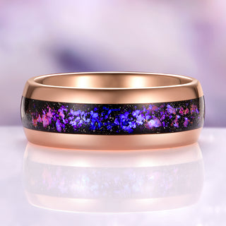 Rose gold ring with purple and blue speckled interior on a light background