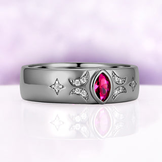 Angled view of the black ruthenium ruby celestial band showing the milgrain-edged crescents, star accents and polished dome profile