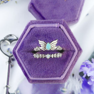 Selene White Fire Opal wing ring and crescent moon band in sterling silver stacked in a purple velvet ring box