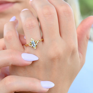 Siren Queen marquise aquamarine lotus ring in yellow gold worn on a model's hand