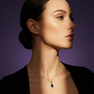 Woman wearing a necklace with a purple background