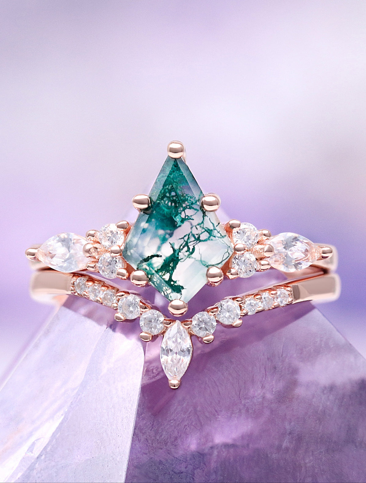 Rose gold ring with a green gemstone on a purple crystal background